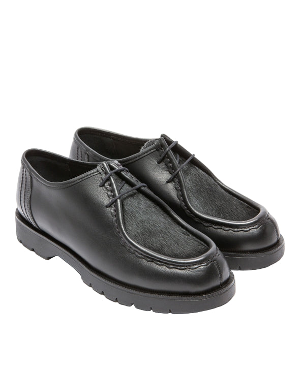 Pair of black leather shoes on a white background