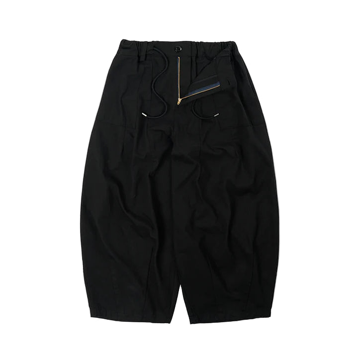 Black pants with a zipper detail on a white background