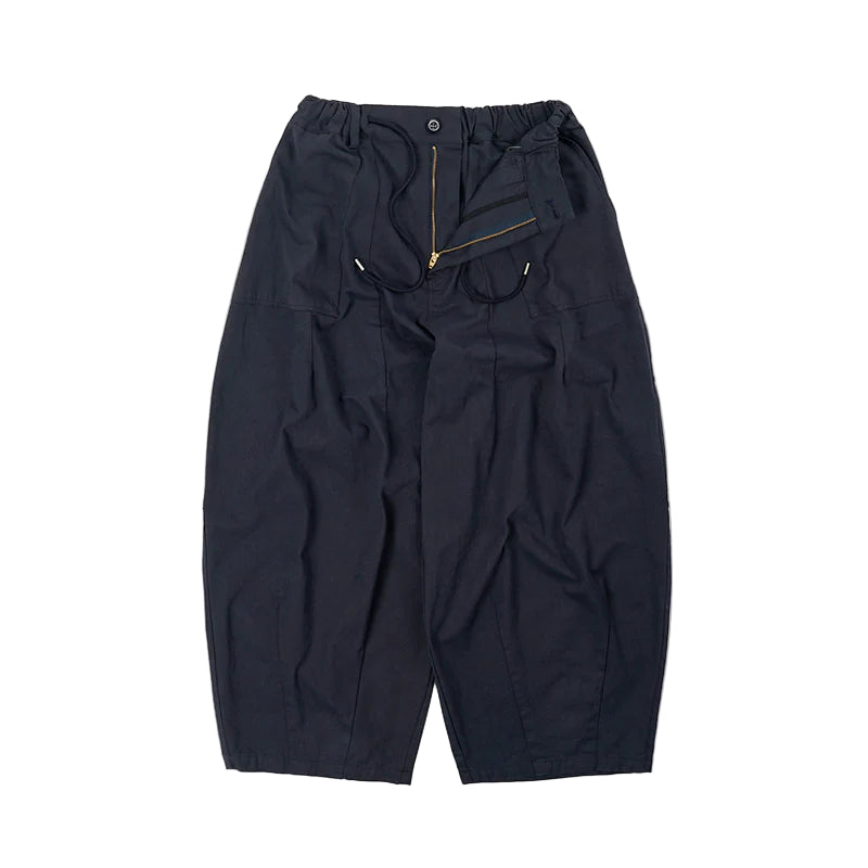 Dark blue pants with a gold zipper on a light gray background